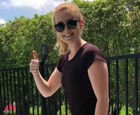 Shelby, smiling and giving the thumbs up.